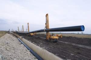 Heavy Duty Construction Machines Carrying Placing Gas Pipe Into Ground