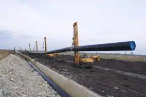 Heavy Duty Construction Machines Carrying Placing Gas Pipe Into Ground